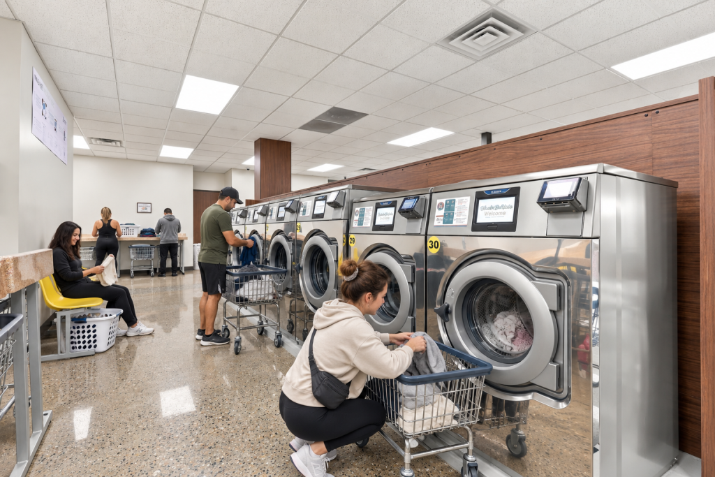 people doing their laundry in wash o matic